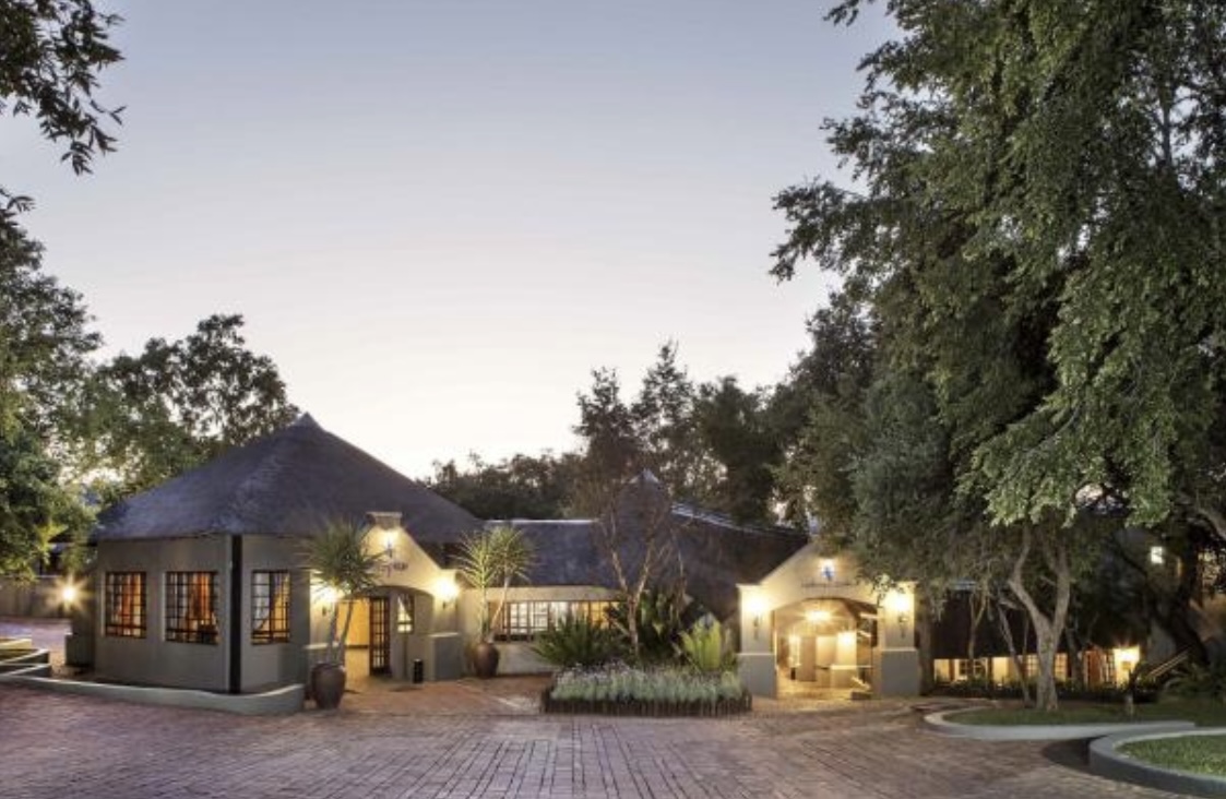 Charming rustic wooden cabin with porch in serene outdoor setting; ideal for nature retreats.